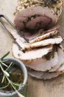 Rolled pork roasted with herbs — Stock Photo