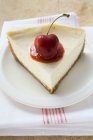 Piece of cheesecake with cherry — Stock Photo
