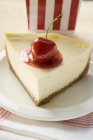 Piece of cheesecake with cherry — Stock Photo