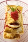 Closeup view of puff pastries with raspberry filling on wire rack — Stock Photo