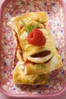Closeup view of stacked puff pastries with raspberry filling in patterned dish — Stock Photo
