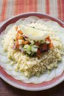 Couscous with cucumber slices — Stock Photo