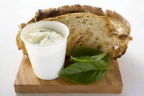 Basil mayonnaise and toasted bread on wooden desk — Stock Photo