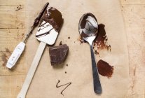 Piece of chocolate on wooden surface — Stock Photo