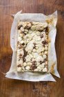 Chocolate slice with macadamia nuts — Stock Photo