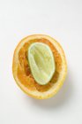 Squeezed lime inside squeezed orange — Stock Photo