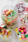 Assorted sweets in storage jars — Stock Photo