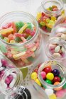 Assorted sweets in storage jars — Stock Photo