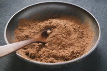 Cocoa powder in bowl — Stock Photo