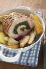 Rolled pork roast with baked potatoes — Stock Photo