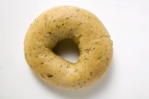 Fresh bagel on white surface — Stock Photo