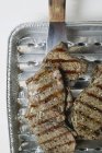 Grilled meat in grill tray — Stock Photo