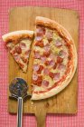 Pizza on chopping board — Stock Photo