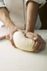 Chef kneading pizza dough — Stock Photo