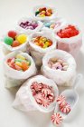 Assorted sweets in paper bags — Stock Photo