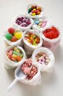 Assorted sweets in paper bags — Stock Photo