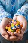 Hands holding jelly beans — Stock Photo