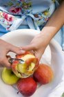 Female hands Peeling apple — Stock Photo