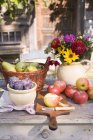 Daytime view of rustic fruit still life on garden table near house — Stock Photo