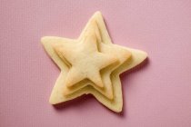 Closeup top view of piled pastry stars on pink surface — Stock Photo