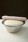 Pizza dough in bowl — Stock Photo