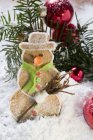 Closeup view of spiced pastry snowman and Christmas decorations — Stock Photo