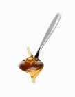 Spoonful of honey on white — Stock Photo