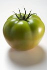 Green beefsteak tomato — Stock Photo
