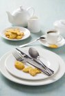 Closeup view of white place setting with biscuits and coffee — Stock Photo