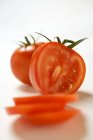 Two tomatoes partly sliced — Stock Photo