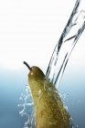 Washing fresh pear — Stock Photo