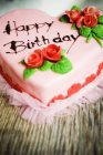 Pink heart-shaped birthday cake — Stock Photo