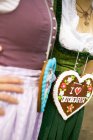 Cropped view of two women with Lebkuchen hearts — Stock Photo