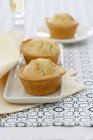 Three muffins on plates — Stock Photo