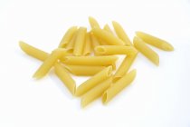 Bunch of raw Penne rigate pasta — Stock Photo
