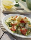 Cucumber salad with melon and strawberries — Stock Photo