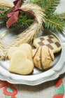 Christmas biscuits on pewter plate — Stock Photo
