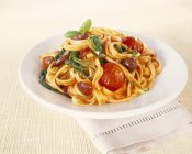 Tagliatelle pasta with cherry tomatoes — Stock Photo