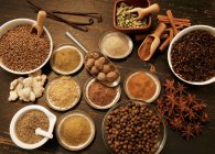 Top view of different spices on wooden table — Stock Photo