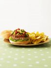 Burger with avocado relish and nachos — Stock Photo