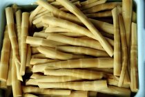Bamboo Shoots laying on blue dish — Stock Photo