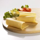Cheese board with lettuce — Stock Photo