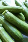 Fresh green courgettes in heap — Stock Photo