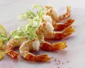 Cooked shrimp tails and frise — Stock Photo