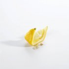 Squeezed lemon wedge — Stock Photo