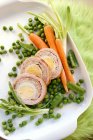 Turkey roulade with egg and summer vegetables on white surface — Stock Photo