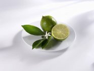 Limes with leaves and flower — Stock Photo
