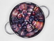 Fresh plums in colander — Stock Photo