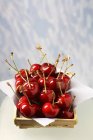 Cherries in wooden dish — Stock Photo
