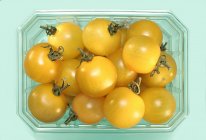 Yellow cherry tomatoes in plastic punnet — Stock Photo